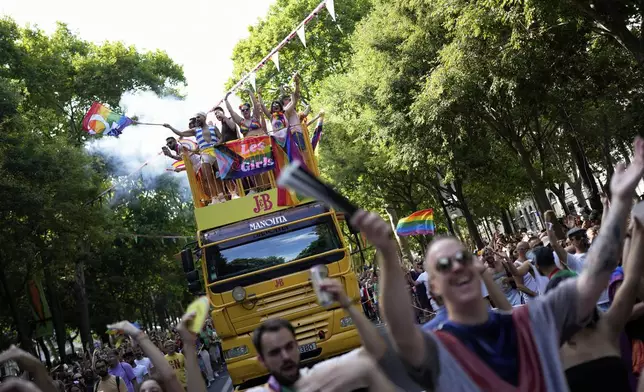Revelers dance down Liberdade Avenue in Lisbon during the Europride Parade, Saturday, June 21, 2025. (AP Photo/Armando Franca)