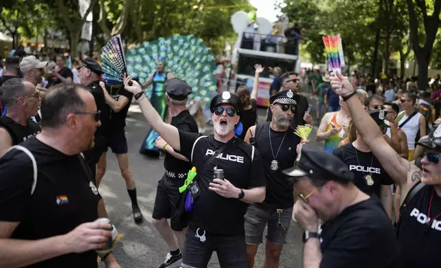 Revelers dance down Liberdade Avenue in Lisbon during the Europride Parade, Saturday, June 21, 2025. (AP Photo/Armando Franca)