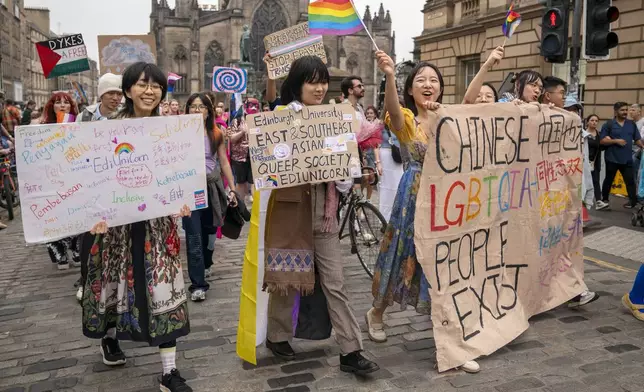 People take part in the Pride Edinburgh 2025 parade through Edinburgh city centre, Scotland, Saturday June 21, 2025. (Jane Barlow/PA via AP)
