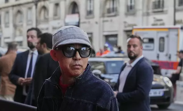 Designer Nigo poses for photographers following the men's Kenzo Spring-Summer 2026 collection, that was presented in Paris, Friday, June 27, 2025. (AP Photo/Michel Euler)