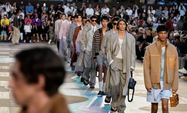 Models wear creations as part of the men's Louis Vuitton Spring-Summer 2026 collection, that was presented in Paris, Tuesday, June 24, 2025. (AP Photo/Michel Euler)