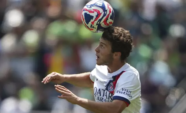 Paris Saint-Germain's Joao Neves heads the ball during the Club World Cup Group B soccer match between Seattle Sounders and PSG in Seattle, Monday, June 23, 2025. (AP Photo/Lindsey Wasson)