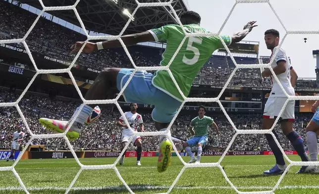 Seattle Sounders' Nouhou Tolo stops a shot by Paris Saint-Germain's Warren Zaire-Emery during the Club World Cup Group B soccer match between Seattle Sounders and PSG in Seattle, Monday, June 23, 2025. (AP Photo/Lindsey Wasson)