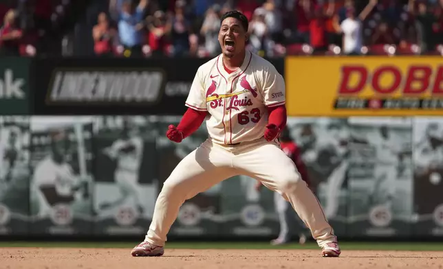 St. Louis Cardinals' Yohel Pozo celebrates after hitting a walk-off single in the 11th inning to defeat the Cincinnati Reds in a baseball game Saturday, June 21, 2025, in St. Louis. (AP Photo/Jeff Roberson)