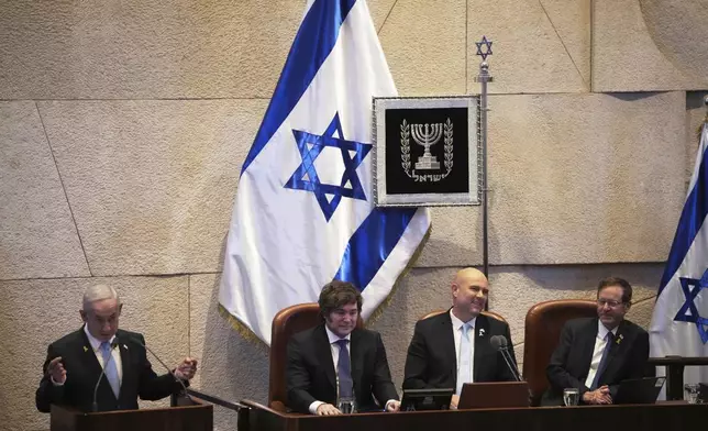 Israel's Prime Minister Benjamin Netanyahu, left, welcomes Argentina's President Javier Milei, center left, flanked by Speaker Amir Ohana, second right and President Isaac Herzog, at the Knesset, Israel's parliament, in Jerusalem, Wednesday, June 11, 2025. (AP Photo/Ohad Zwigenberg)