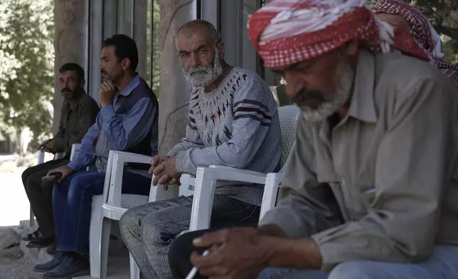 Ahmad Hammadi, center, receives condolences on the death of his son Mohammed who was killed during an Israeli pre-dawn raid on Beit Jin village, southern Syria, Thursday, June 12, 2025. (AP Photo/Omar Sanadiki)