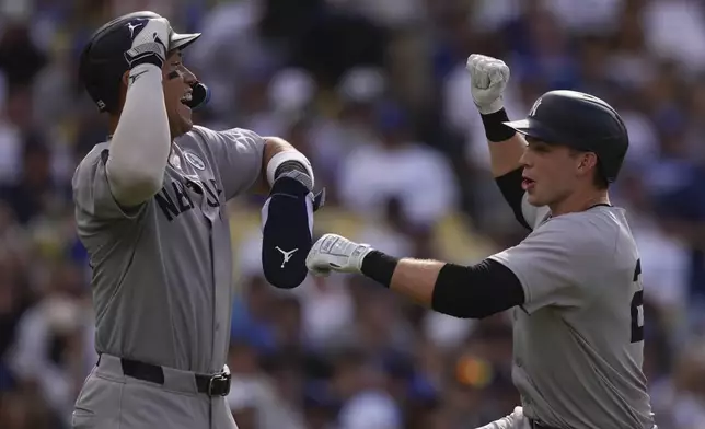 New York Yankees' Ben Rice, right, is congratulated by Aaron Judge after hitting a two-run home run during the third inning of a baseball game against the Los Angeles Dodgers, Sunday, June 1, 2025, in Los Angeles. (AP Photo/Mark J. Terrill)