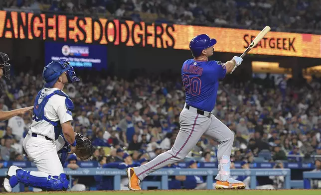 New York Mets' Pete Alonso, right, hits a three-run home run as Los Angeles Dodgers catcher Dalton Rushing watches during the eighth inning of a baseball game Wednesday, June 4, 2025, in Los Angeles. (AP Photo/Mark J. Terrill)