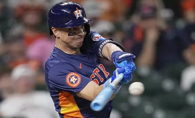 Houston Astros' Mauricio Dubón hits a game-winning RBI single against the Minnesota Twins during the 10th inning of a baseball game Sunday, June 15, 2025, in Houston. (AP Photo/David J. Phillip)