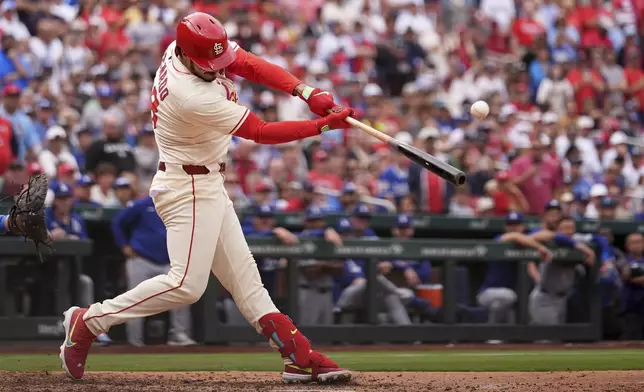 St. Louis Cardinals' Nolan Arenado hits a walk-off single to defeat the Los Angeles Dodgers in a baseball game Saturday, June 7, 2025, in St. Louis. (AP Photo/Jeff Roberson)