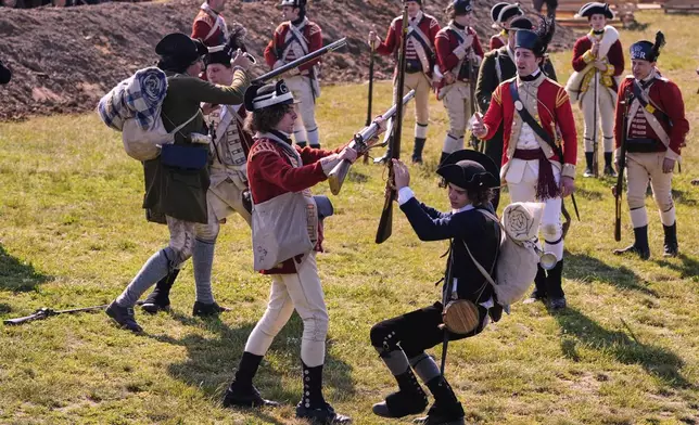 British and Colonial soldiers engage during a reenactment in celebration of the 250th anniversary of the Battle of Bunker Hill, Saturday, June 21, 2025, in Gloucester, Mass. (AP Photo/Charles Krupa)