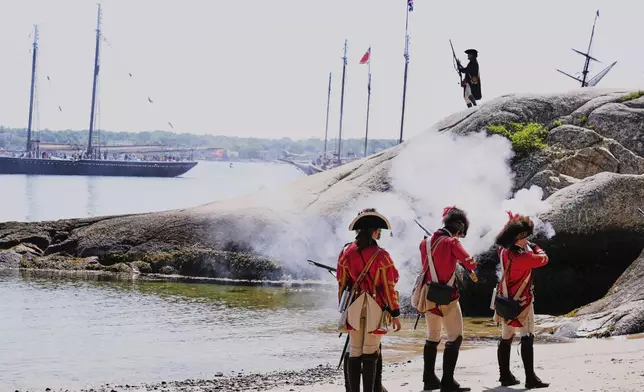British soldiers on the beach engage a Colonial soldier during a reenactment in celebration of the 250th anniversary of the Battle of Bunker Hill, Saturday, June 21, 2025, in Gloucester, Mass. (AP Photo/Charles Krupa)