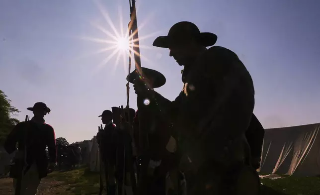 Colonial soldiers prepare to face the British during a reenactment in celebration of the 250th anniversary of the Battle of Bunker Hill, Saturday, June 21, 2025, in Gloucester, Mass. (AP Photo/Charles Krupa)