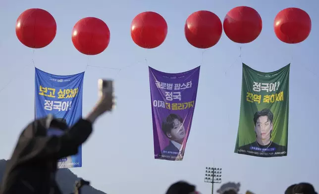 Fans wait for arrival of K-pop band BTS members Jimin and Jung Kook in Yeoncheon, South Korea, Wednesday, June 11, 2025. (AP Photo/Lee Jin-man)