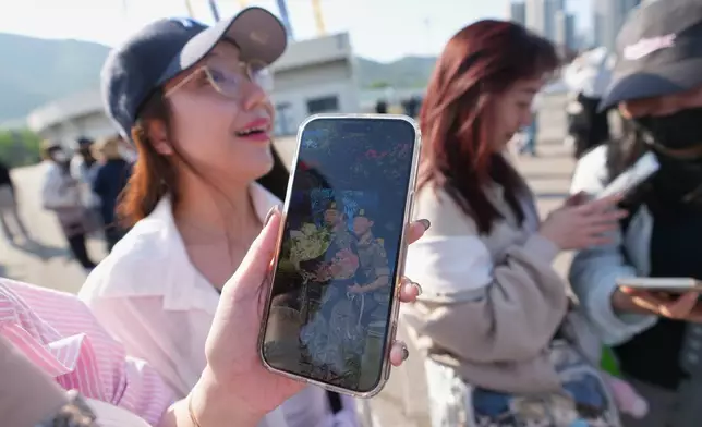 Fans react after she saw K-pop band BTS members Jimin and Jung Kook as they are discharged from a mandatory military service in Yeoncheon, South Korea, Wednesday, June 11, 2025. (AP Photo/Lee Jin-man)