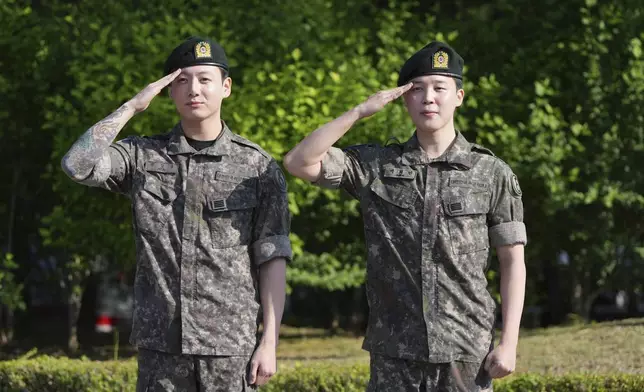 K-pop band BTS members Jimin, right, and Jung Kook salute after being discharged from a mandatory military service in Yeoncheon, South Korea, Wednesday, June 11, 2025. (AP Photo/Lee Jin-man)