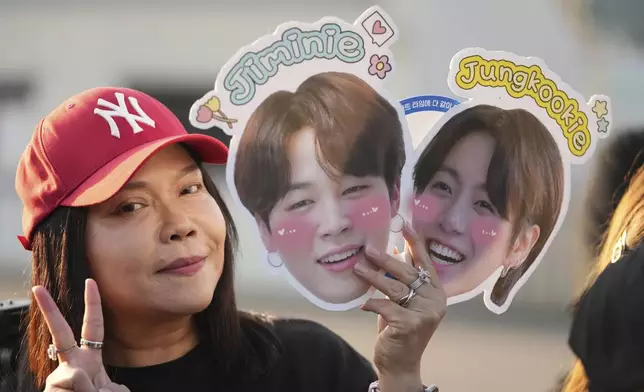 A fan from Thailand waits for arrival of K-pop band BTS members Jimin and Jung Kook in Yeoncheon, South Korea, Wednesday, June 11, 2025. (AP Photo/Lee Jin-man)