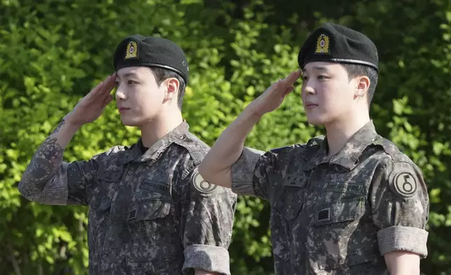 K-pop band BTS members Jimin, right, and Jung Kook salute after being discharged from a mandatory military service in Yeoncheon, South Korea, Wednesday, June 11, 2025. (AP Photo/Lee Jin-man)