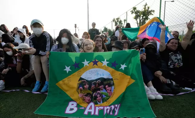 Fans wait for arrival of K-pop band BTS members RM and V before they are discharged from a mandatory military service in Chuncheon, South Korea, Tuesday, June 10, 2025. (AP Photo/Ahn Young-joon)