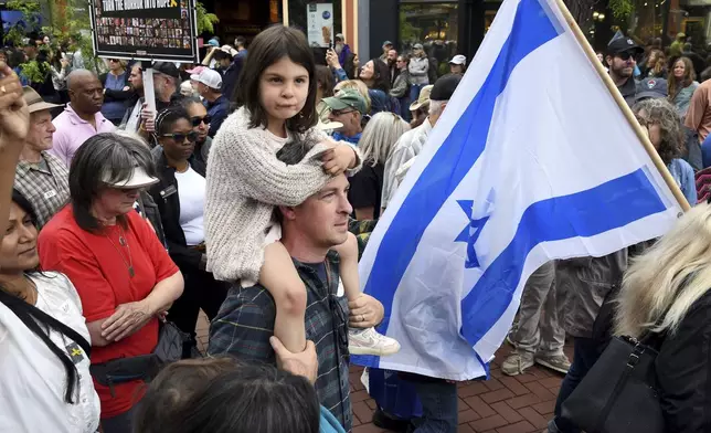 Former Colorado State Sen. Steve Fenberg marches with his daughter Isa in Boulder, Colo., on Sunday, June 8, 2025, to call for the release of Israeli hostages. (AP Photo/Thomas Peipert)