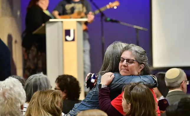 Women embrace before a community vigil at the Boulder Jewish Community Center to mark an attack in Boulder, Colo., Wednesday, June 4, 2025. (Andy Cross/The Denver Post via AP, Pool)