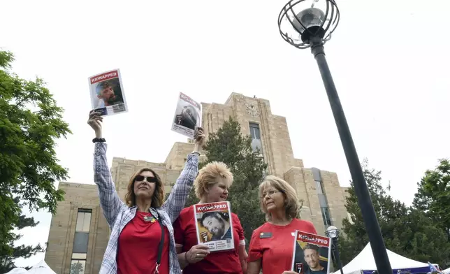 Colorado State Rep. Lori Garcia Sander, left, state GOP Chair Brita Horn, center, and state Sen. Barbara Kirkmeyer, right, show support for the hostages held in Gaza during the Boulder Jewish Festival in Boulder, Colo., on Sunday, June 8, 2025.(AP Photo/Thomas Peipert)