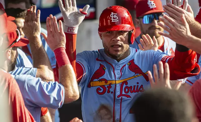 St. Louis Cardinals' Willson Contreras is congratulated by his teammates after hitting a solo home run off Cleveland Guardians relief pitcher Kolby Allard during the ninth inning of a baseball game, Saturday, June 28, 2025, in Cleveland. (AP Photo/Phil Long)