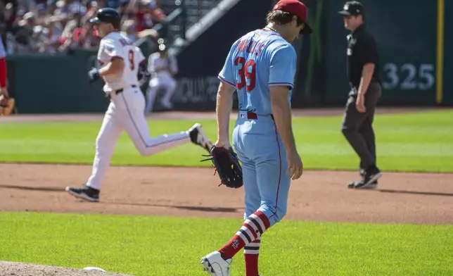 St. Louis Cardinals starting pitcher Miles Mikolas steps off the mound after giving up a solo home run to Cleveland Guardians' Kyle Manzardo, rear, during the fourth inning of a baseball game, Saturday, June 28, 2025, in Cleveland. (AP Photo/Phil Long)