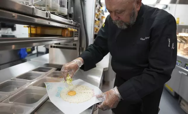 Charles L. Krumsiek, a McDonald's chef, makes a snack wrap (ranch) at McDonald's Headquarter in Chicago, Thursday, May 29, 2025. (AP Photo/Nam Y. Huh)