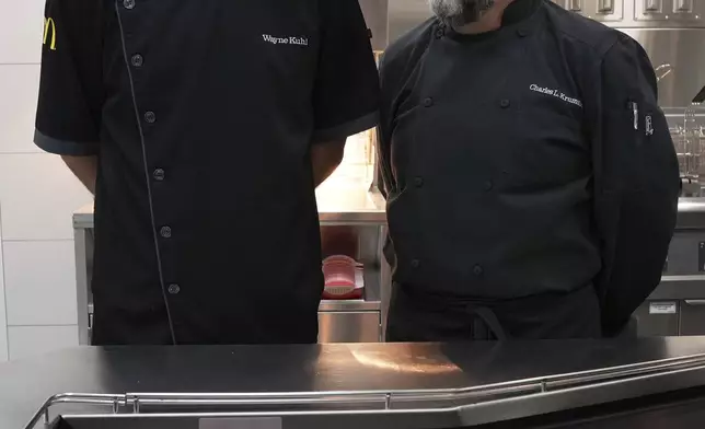 Wayne Kuhl, left, and Charles L. Krumsieka, McDonald's chefs look at each other after made snack wraps at McDonald's Headquarter in Chicago, Thursday, May 29, 2025. (AP Photo/Nam Y. Huh)