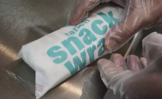 Wayne Kuhl, a McDonald's chef, wraps a snack wrap at McDonald's Headquarter in Chicago, Thursday, May 29, 2025. (AP Photo/Nam Y. Huh)