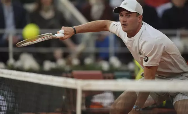 Tommy Paul of the U.S. plays a shot against Spain's Carlos Alcaraz during their quarterfinal match of the French Tennis Open at the Roland-Garros stadium in Paris, Tuesday, June 3, 2025. (AP Photo/Thibault Camus)