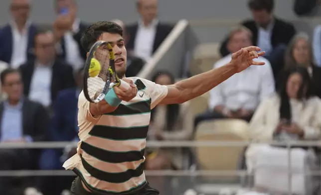 Spain's Carlos Alcaraz plays a shot against Tommy Paul of the U.S. during their quarterfinal match of the French Tennis Open at the Roland-Garros stadium in Paris, Tuesday, June 3, 2025. (AP Photo/Thibault Camus)
