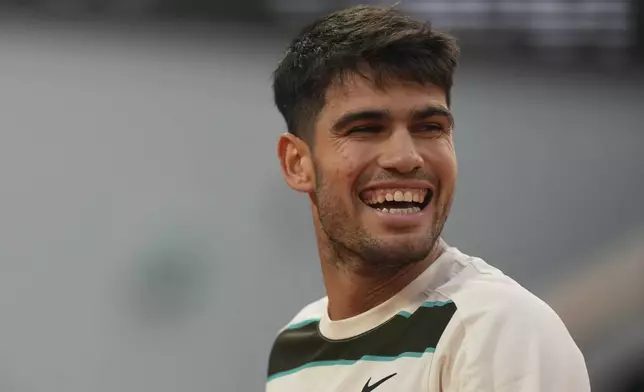 Spain's Carlos Alcaraz smiles as he plays against Tommy Paul of the U.S. during their quarterfinal match of the French Tennis Open at the Roland-Garros stadium in Paris, Tuesday, June 3, 2025. (AP Photo/Thibault Camus)