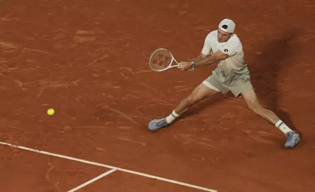 Tommy Paul of the U.S. plays a shot against Spain's Carlos Alcaraz during their quarterfinal match of the French Tennis Open at the Roland-Garros stadium in Paris, Tuesday, June 3, 2025. (AP Photo/Thibault Camus)