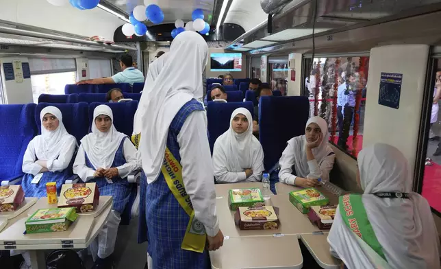 passengers get refreshments inside Vande Bharat Express train which is soon to be inaugurated to run between Srinagar and Katra, in Srinagar, Indian controlled Kashmir, Friday, June 6, 2025. (AP Photo/Dar Yasin)