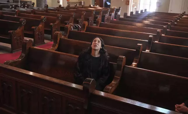 Art conservator Naomi Ruiz looks at murals by Croatian-American artist Maxo Vanka in St. Nicholas Croatian Catholic Church in Millvale, Pa., Jan. 21, 2025. (AP Photo/Gene J. Puskar