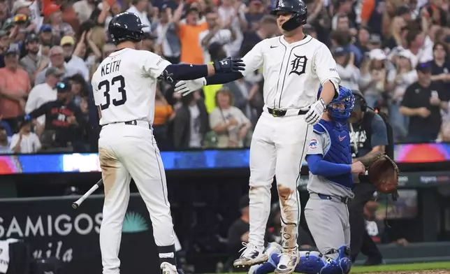 Detroit Tigers' Spencer Torkelson celebrates his home run with Colt Keith (33) against the Chicago Cubs in the sixth inning during a baseball game, Friday, June 6, 2025, in Detroit. (AP Photo/Paul Sancya)