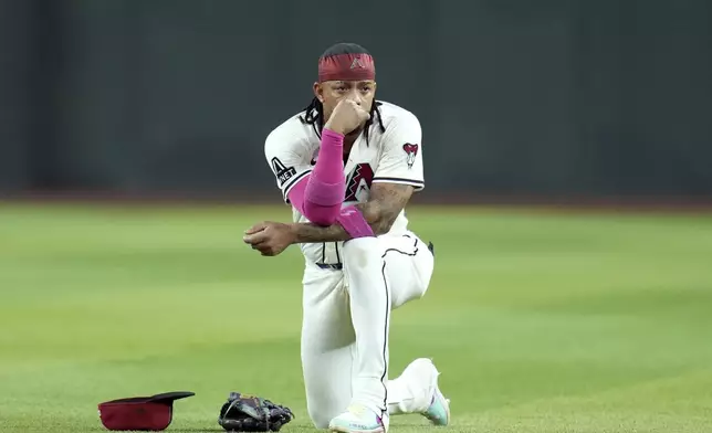 Arizona Diamondbacks second baseman Ketel Marte pauses on the field as Diamondbacks pitcher Justin Martinez leaves the game due to injury during the ninth inning of a baseball game against the Seattle Mariners Monday, June 9, 2025, in Phoenix. (AP Photo/Ross D. Franklin)
