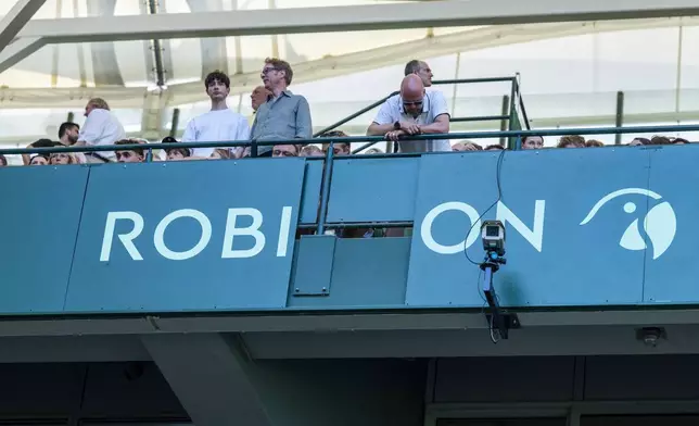 A billboard has come loose from the stands and fallen into the spectator area during the Halle ATP tennis tournament in Halle, Germany, Wednesday, June 18, 2025. (David Inderlied/dpa via AP)