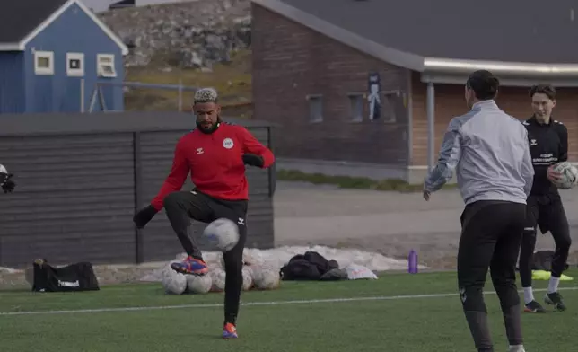 Patrick Frederiksen, captain of Greenland's national team, kicks the ball during a training session at Nuuk stadium in Nuuk, Greenland, Tuesday, June 17, 2025. (AP Photo/Kwiyeon Ha)