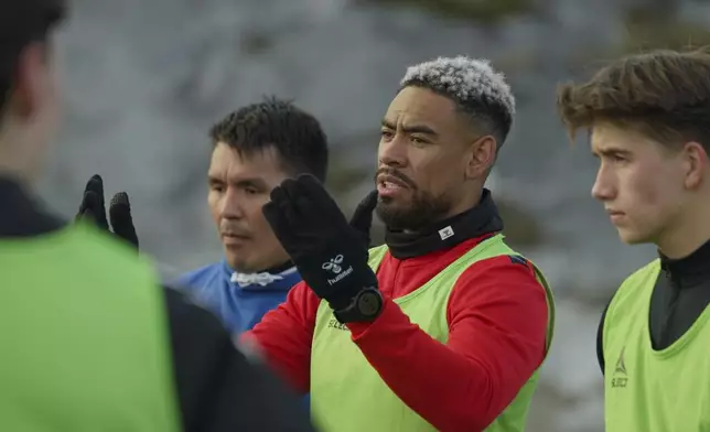 Patrick Frederiksen, captain of Greenland's national team, speaks to players during the training at Nuuk stadium in Nuuk, Greenland, Tuesday, June 17, 2025. (AP Photo/Kwiyeon Ha)