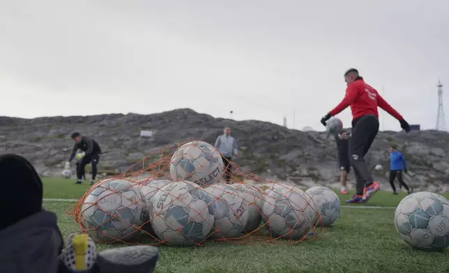Soccer balls lie on a pitch of Nuuk stadium in Nuuk, Greenland, Tuesday, June 17, 2025. (AP Photo/Kwiyeon Ha)