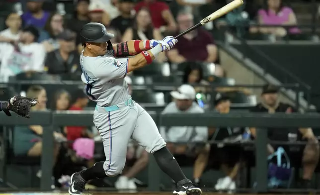 Miami Marlins' Heriberto Hernandez connects for a home run against the Arizona Diamondbacks during the eighth inning of a baseball game Friday, June 27, 2025, in Phoenix. (AP Photo/Ross D. Franklin)
