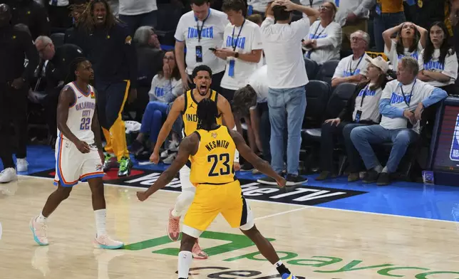 Indiana Pacers guard Tyrese Haliburton celebrates with forward Aaron Nesmith (23) after making a 3-pointer during the second half of Game 1 of the NBA Finals basketball series against the Oklahoma City Thunder Thursday, June 5, 2025, in Oklahoma City. (AP Photo/Nate Billings)