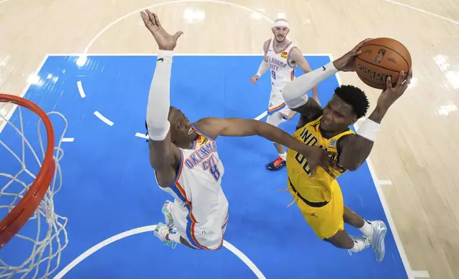 Indiana Pacers guard Bennedict Mathurin (00) shoots against Oklahoma City Thunder forward Jalen Williams (8) during the second half in Game 1 of the NBA Finals basketball series Thursday, June 5, 2025, in Oklahoma City. (Kyle Terada/Pool Photo via AP)