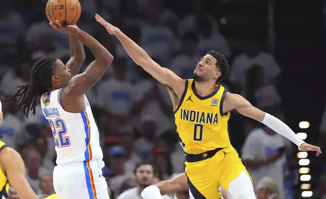 Oklahoma City Thunder guard Cason Wallace (22) shoots against Indiana Pacers guard Tyrese Haliburton (0) during the second half of Game 1 of the NBA Finals basketball series Thursday, June 5, 2025, in Oklahoma City. (AP Photo/Julio Cortez)