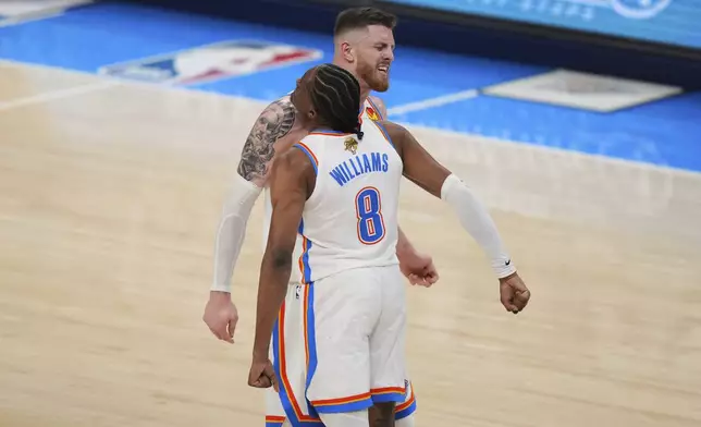 Oklahoma City Thunder forward Jalen Williams (8) celebrateswith center Isaiah Hartenstein (55) after a dunk during the second half of Game 1 of the NBA Finals basketball series against the Indiana Pacers Thursday, June 5, 2025, in Oklahoma City. (AP Photo/Nate Billings)