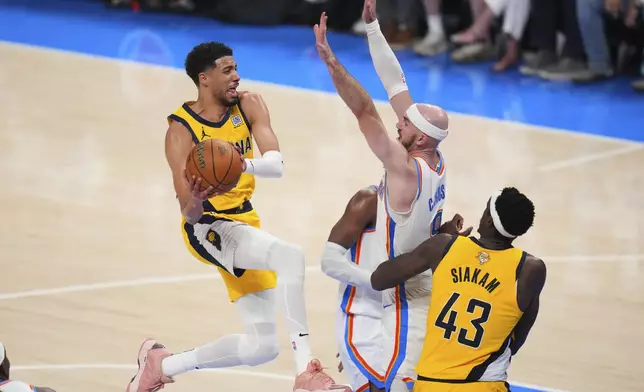 Indiana Pacers guard Tyrese Haliburton (0) shoots against Oklahoma City Thunder guard Alex Caruso (9) during the second half of Game 1 of the NBA Finals basketball series Thursday, June 5, 2025, in Oklahoma City. (AP Photo/Julio Cortez)