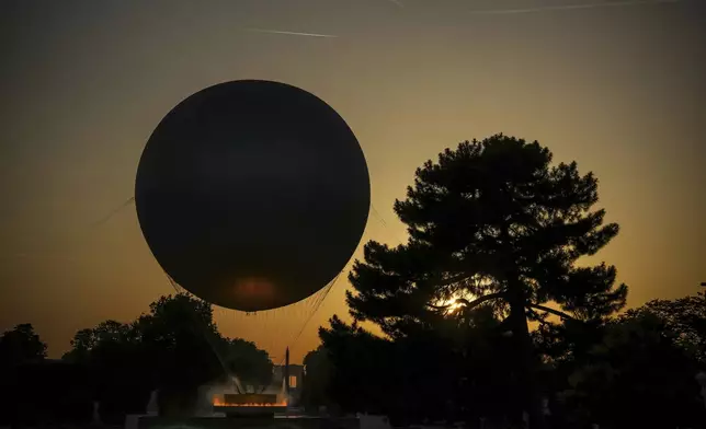 The helium ballon that was used during the 2024 Olympic Games as the Olympic cauldron is launched in the Tuileries Gardens of Paris on Saturday, June 21, 2025. (AP Photo/Aurelien Morissard)